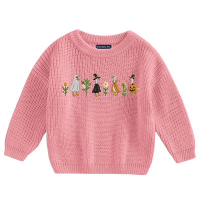 Pink sweater with embroidered design on a white background