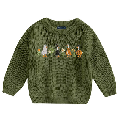 Green knitted sweater with embroidered design on a white background