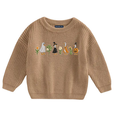Brown sweater with embroidered design on a white background