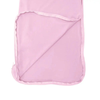 Pink baby blanket with ruffled edge on a white background