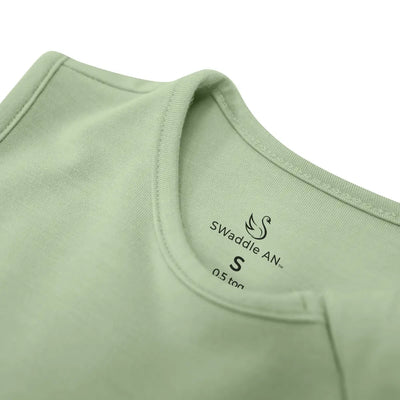 Close-up of a green baby wrap with 'Swaddle AN' branding on a white background