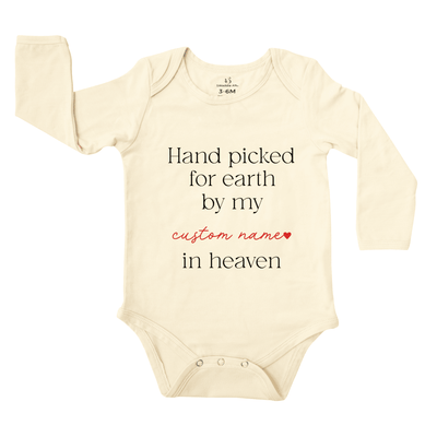 Beige baby onesie with text on a white background