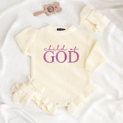 Baby romper with 'Child of God' text on a white background
