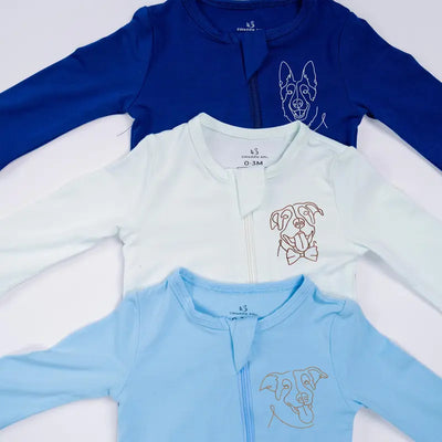 Three baby onesies in blue, white, and light blue with a dog illustration on a white background.