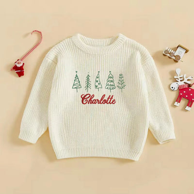 White sweater with Christmas tree design and 'Charlotte' text on a beige background