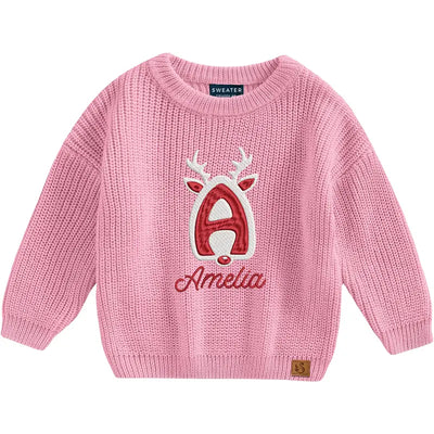 Pink sweater with a reindeer design and 'Amelia' text on a white background