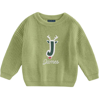 Green knitted sweater with a embroidered design on a white background