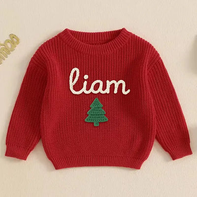 Red sweater with 'liam' and a green tree on a beige background
