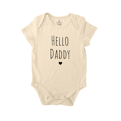 Beige baby onesie with 'Hello Daddy' text on a white background