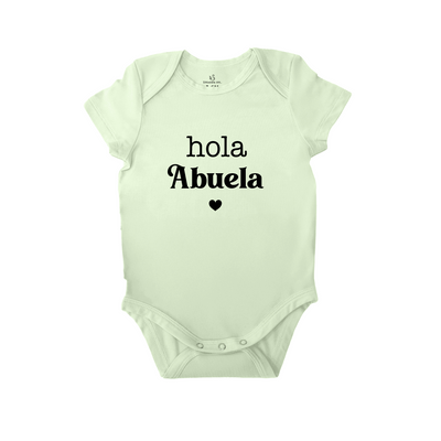 Light green baby onesie with 'Hola Abuela' text on a white background