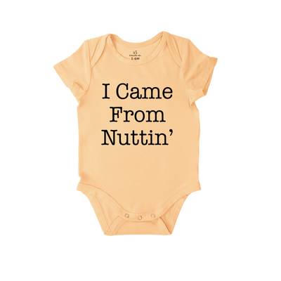 Beige baby onesie with 'I Came From Nuttin'' text on a white background