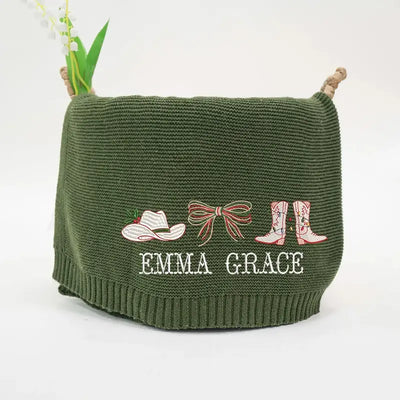 Green knitted bag with embroidered designs and 'Emma Grace' text on a white background