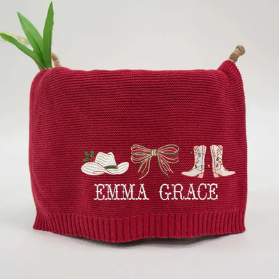 Red knitted pouch with embroidered design and 'Emma Grace' text on a white background