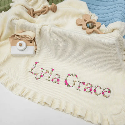 Personalized Floral Knit Baby Blanket is more than a cozy wrap; it is a blooming garden of comfort, where delicate flowers are embroidered around their name