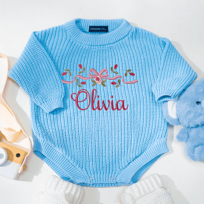 Blue baby romper with embroidered name 'Olivia' on a white background