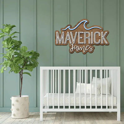 Nursery with white crib, plant, and personalized wooden sign on green paneled wall.