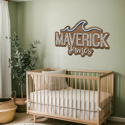 Nursery room with wooden crib and personalized name sign on the wall.
