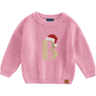 Pink sweater with a letter 'B' design on a white background