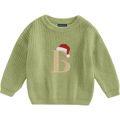 Green knitted sweater with a letter 'B' and Santa hat design on a white background