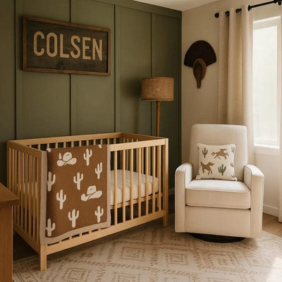 Nursery room with wooden crib, beige chair, and decorative elements.