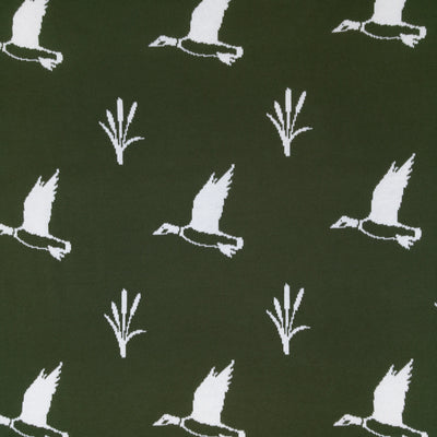 Pattern of white birds and plants on a black background