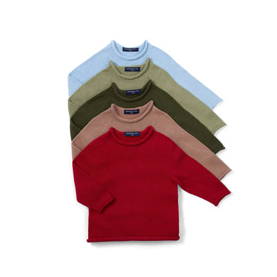 Stack of five folded sweaters in red, brown, green, and blue on a white background