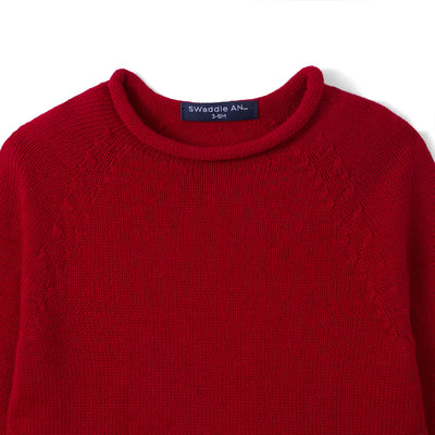Red sweater with a brand label on a white background