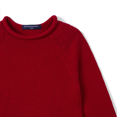 Red sweater with a brand label on a white background