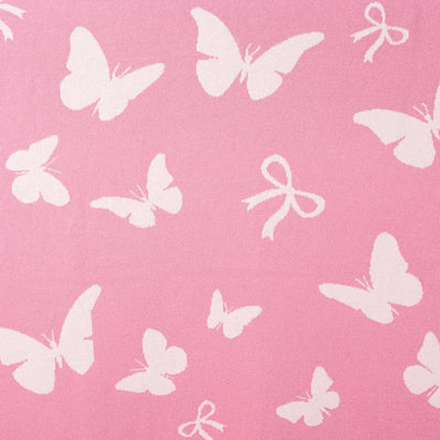 White butterflies and bows on a pink background