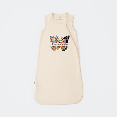Sand baby sleeping bag with butterfly design and 'Annastasia' text on a white background
