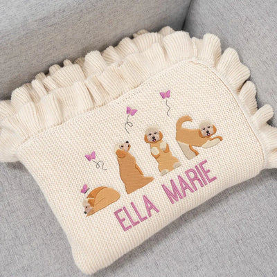 Personalized baby girl blanket with embroidered golden doodles and 'Ella Marie' text on a gray surface