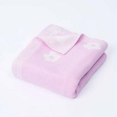Pink blanket with a heart design on a white background