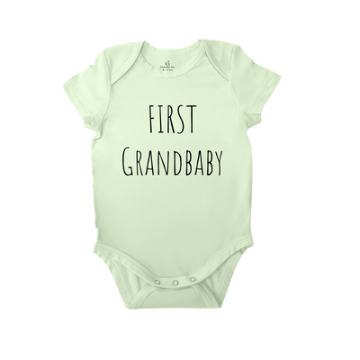 Light green baby onesie with 'First Grandbaby' text on a white background
