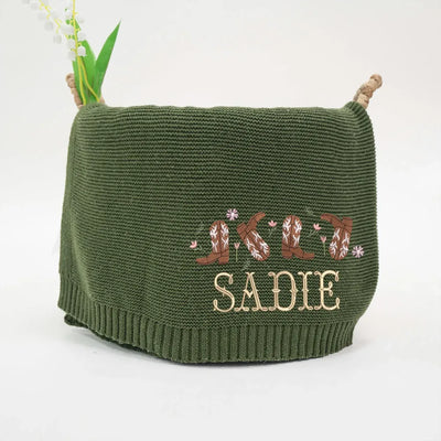 Forest green personalized baby blanket with embroidered name 'Sadie' on a white background