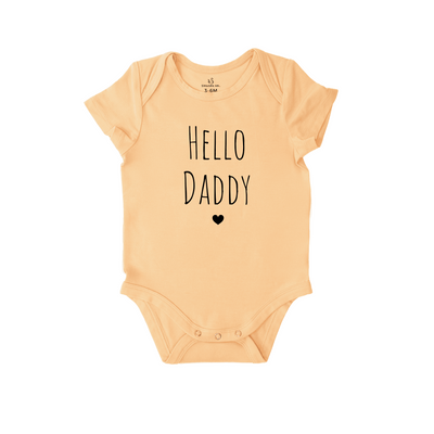 Beige baby onesie with 'Hello Daddy' text on a white background