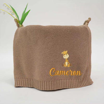 Mocha personalized baby blanket with embroidered giraffe and 'Cameron' text on a white background