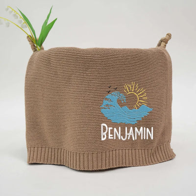 Mocha personalized baby blanket with embroidered ocean waves design and 'Benjamin' text on a white background