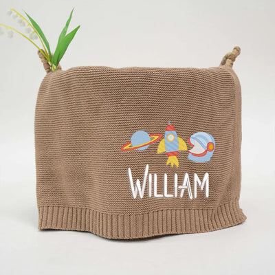 Mocha personalized baby blanket with rocket space ship design and 'William' text on a white background