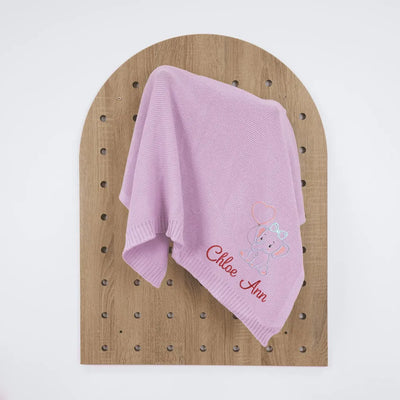 Lilac personalized baby blanket with embroidered name and elephant design on a wooden board