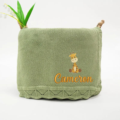 Sage green personalized baby blanket with a embroidered giraffe and 'Cameron' text on a white background