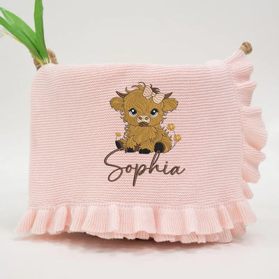 Pink personalized baby girl blanket with a highland cow and 'Sophia' text on a white background