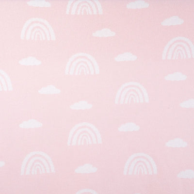 Pattern of rainbows and clouds on a pink background