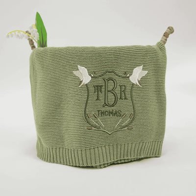Sage green personalized baby blanket with 'TBR' mallard duck crest on a white background