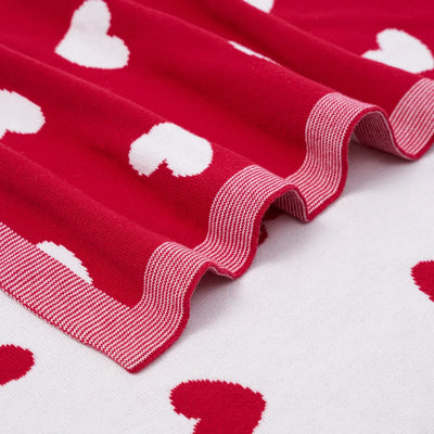 Red fabric with white heart patterns on a white background